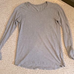 Size 4 light grey lululemon long sleeve light weight top. Not tight.